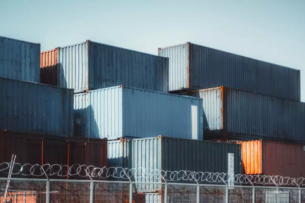 Stacked shipping containers showing visible rust and wear.