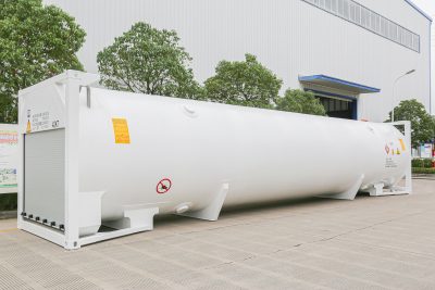 White ISO tank container in front of a building